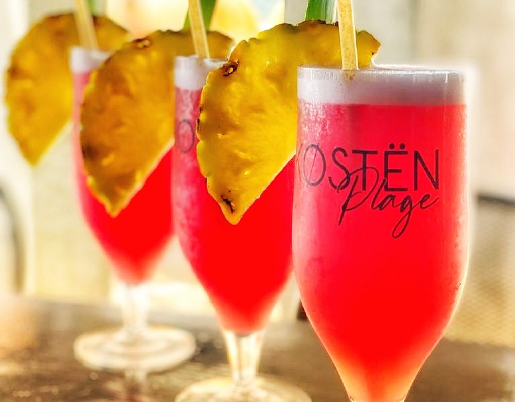 3 cocktails de fruits rouges, servis dans des flûtes avec tranches d'ananas